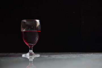 Red wine in wine glass on the table/Low-key concept