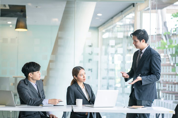 Business team discussing together in conference room during meeting at office. Teamwork, brainstorm and ideas concept. saleperson using tablet and presentation somthing to client.