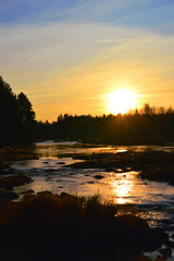 Fototapeta na wymiar Autumn morning in Koiteli rapid, Kiiminki river. Sunset, light of dawn. Beatiful colors, flowing water. Koitelinkoski, Kiiminkijoki. 