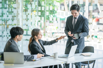 Business team discussing together in conference room during meeting at office. Teamwork, brainstorm and ideas concept. saleperson using tablet and presentation somthing to client.