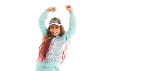 Teenage girl with long blonde hair dyed with tips pink, in shiny white cap, light blue sports suit, belt bag stands and rejoices