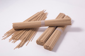 dried soba noodles on a white background