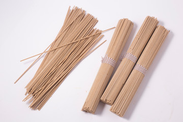 dried soba noodles on a white background