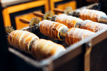 Traditional Czech Christmas culture pastry trdelnik. This bread prepared on the street from yeast dough, baked on metal skewers