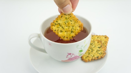 Hot tea and vegetable cracker or biscuit . Hi tea or tea break concept.