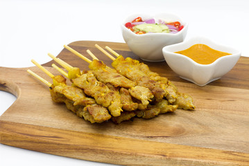 pork satay in Chopping Wood on wooden table and sauce