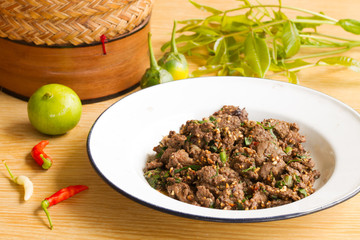 Beef salad in a white plate on a wooden table. , Space for text input