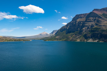 Fototapeta premium Saint Mary lake in the Glacier national park, Montana on a bright summer day with few clouds in the sky.