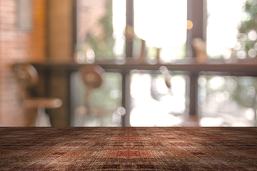 Top desk with blur restaurant background,wooden table