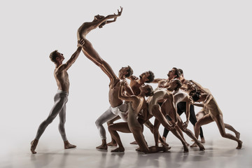 The group of modern ballet dancers. Contemporary art ballet. Young flexible athletic men and women...