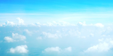 blue sky background with clouds, beautiful cloudscape, view over white fluffy clouds, freedom concept