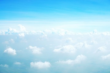 blue sky background with clouds, beautiful cloudscape, view over white fluffy clouds, freedom concept