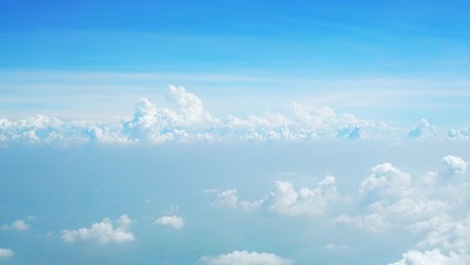 blue sky background with clouds, beautiful cloudscape, view over white fluffy clouds, freedom concept