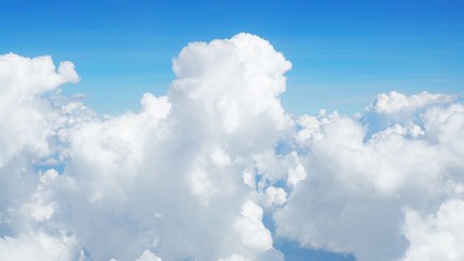 blue sky background with clouds, beautiful cloudscape, view over white fluffy clouds, freedom concept
