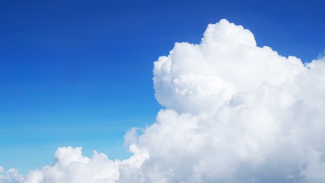 blue sky background with clouds, beautiful cloudscape, view over white fluffy clouds, freedom concept