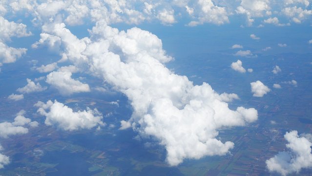 blue sky background with clouds, beautiful cloudscape, view over white fluffy clouds, freedom concept