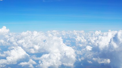 blue sky background with clouds, beautiful cloudscape, view over white fluffy clouds, freedom concept