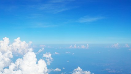 blue sky background with clouds, beautiful cloudscape, view over white fluffy clouds, freedom concept