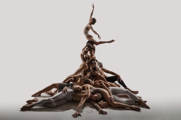 The group of modern ballet dancers. Contemporary art ballet. Young flexible athletic men and women...