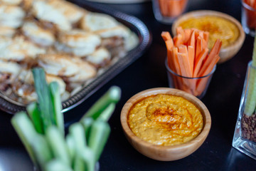 Carrot and cucumber sticks ready for dipping in hummus bowl