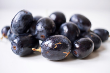 Big black spanish grapes over a white background