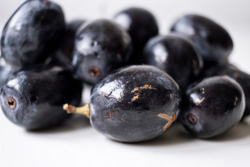 Big black spanish grapes over a white background