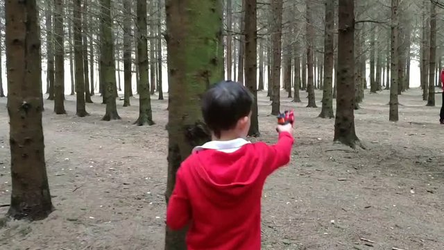 Father with son playing shooting game.