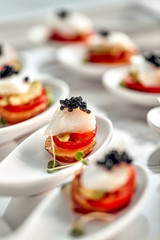 Delicious tartlets with black caviar. Concept of food, restaurant, catering, menu.