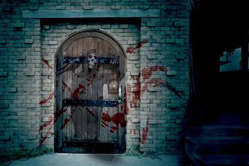 Antique wooden door on brick wall with Grim Reaper,Halloween day,haunted house