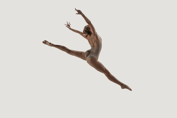 Modern ballet dancer. Contemporary art ballet. Young flexible athletic woman.. Studio shot isolated on white background. Negative space.