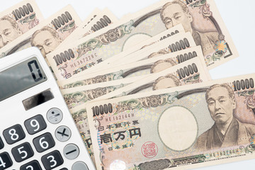 Fototapeta premium Close up calculator on japanese currency yen money banknote. Background concept for japan economy.