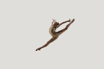 Modern ballet dancer. Contemporary art ballet. Young flexible athletic woman.. Studio shot isolated...