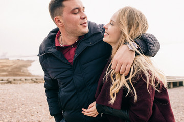 couple hugging on a pier