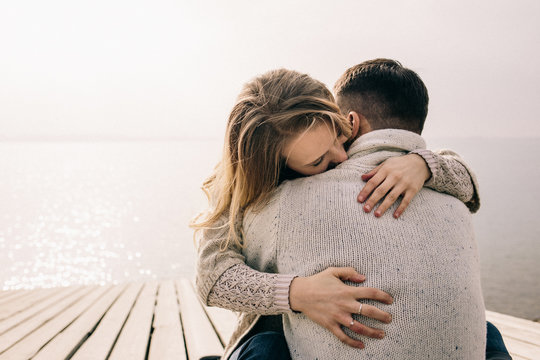couple hugging on a pier