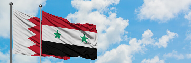 Naklejka premium Bahrain and Syria flag waving in the wind against white cloudy blue sky together. Diplomacy concept, international relations.