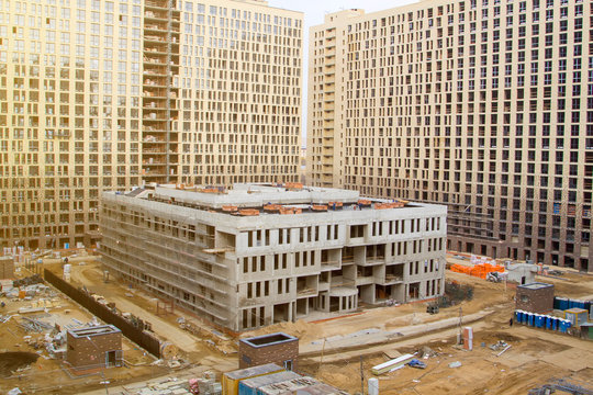 School Building Under Construction In Courtyard Of Apartment Buildings. Business Class Residential Complex Under Construction With School In Yard