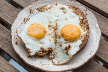 Fried Eggs with Sesame Seeds on Bread for Breakfast.
