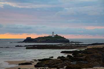 Fototapeta na wymiar Sunset over a rocky island off the coast of Cornwall