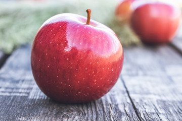 Ripe red apple lies on a wooden table. Vitamins and a healthy diet. Vegetarian concept.