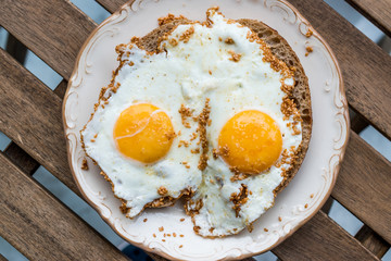 Fried Eggs with Sesame Seeds on Bread for Breakfast.