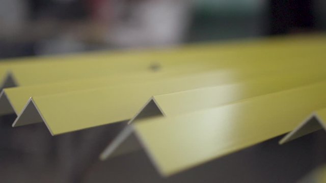 Steel metal L-Profile bar ready to be shipped from the metal workshop. Slow motion. 