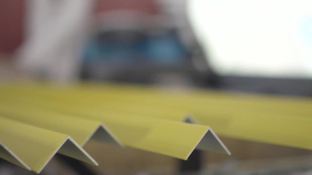 Freshly painted L-Profile bars. Ready to be prepared for shipment at the metal factory. Slow motion.