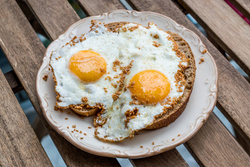 Fried Eggs with Sesame Seeds on Bread for Breakfast.