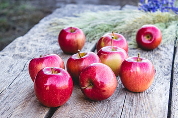 A lot of apples on a wooden table. Vitamins and a healthy diet. Vegetarian concept.