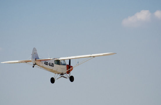 SDE TEYMAN, ISRAEL - DECEMBER 28, 2012: Aircraft Piper PA-18-150 Super Cub on fly on the backgroynd of the sky