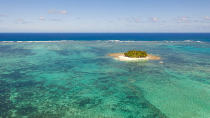 Guyam island, Siargao, Philippines. Small island with palm trees and a white sandy beach. Philippine Islands.