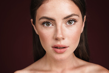 Image of young half-naked woman posing and looking at camera