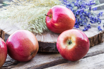 Pile of red fresh apples on a wooden table. Vitamins and a healthy diet. Vegetarian concept.