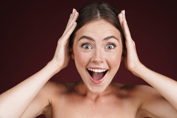 Image of astonished half-naked woman grabbing her head