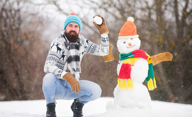 Lets do this. bearded man build snowman. Happy new year. winter season. Merry christmas. winter holiday. warm sweater in cold weather. man having fun. happy hipster ready for xmas